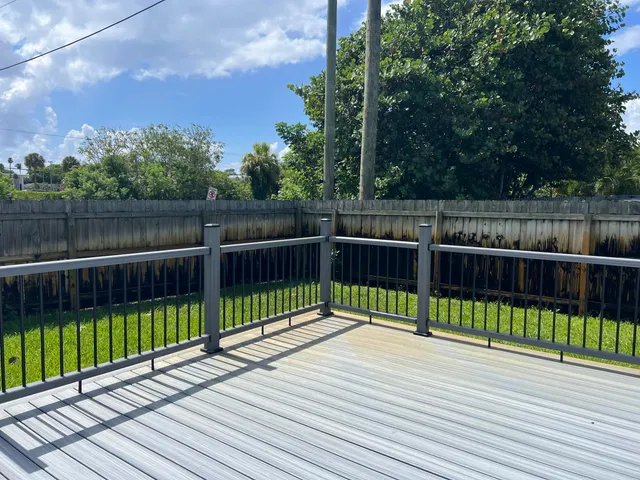 a view of a deck with a large trees