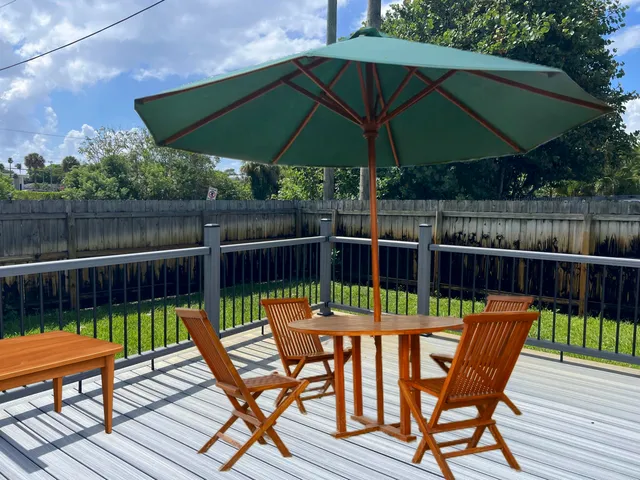 a view of a chairs and table on the wooden deck