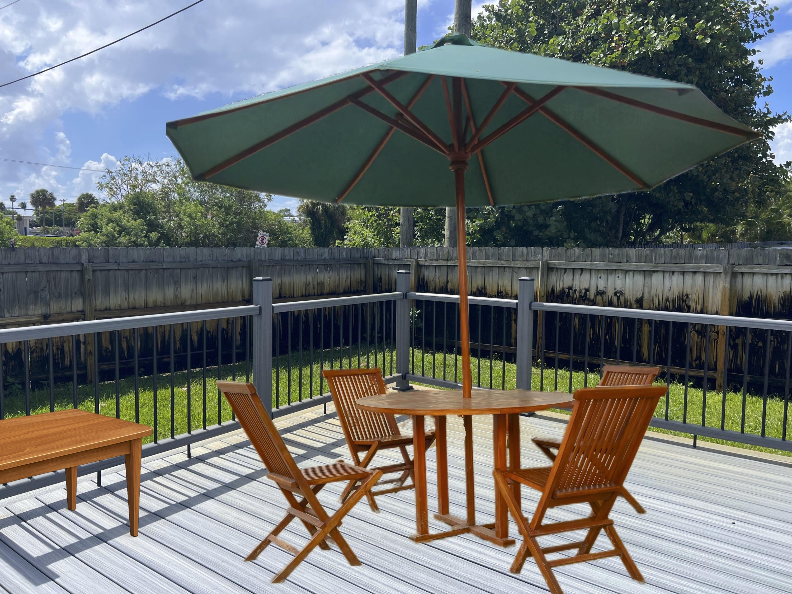 222 Southeast 3rd Street Boynton Beach, FL 33435 - Photo 36 of 40 a view of a chairs and table on the wooden deck