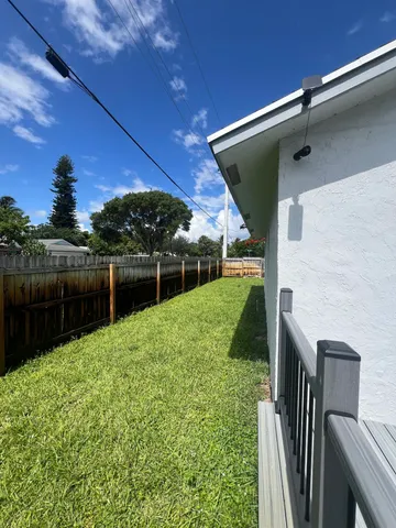a view of backyard with seating area and green space