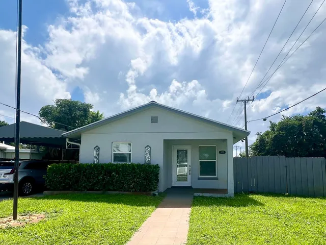 a view of a yard in front view of a house
