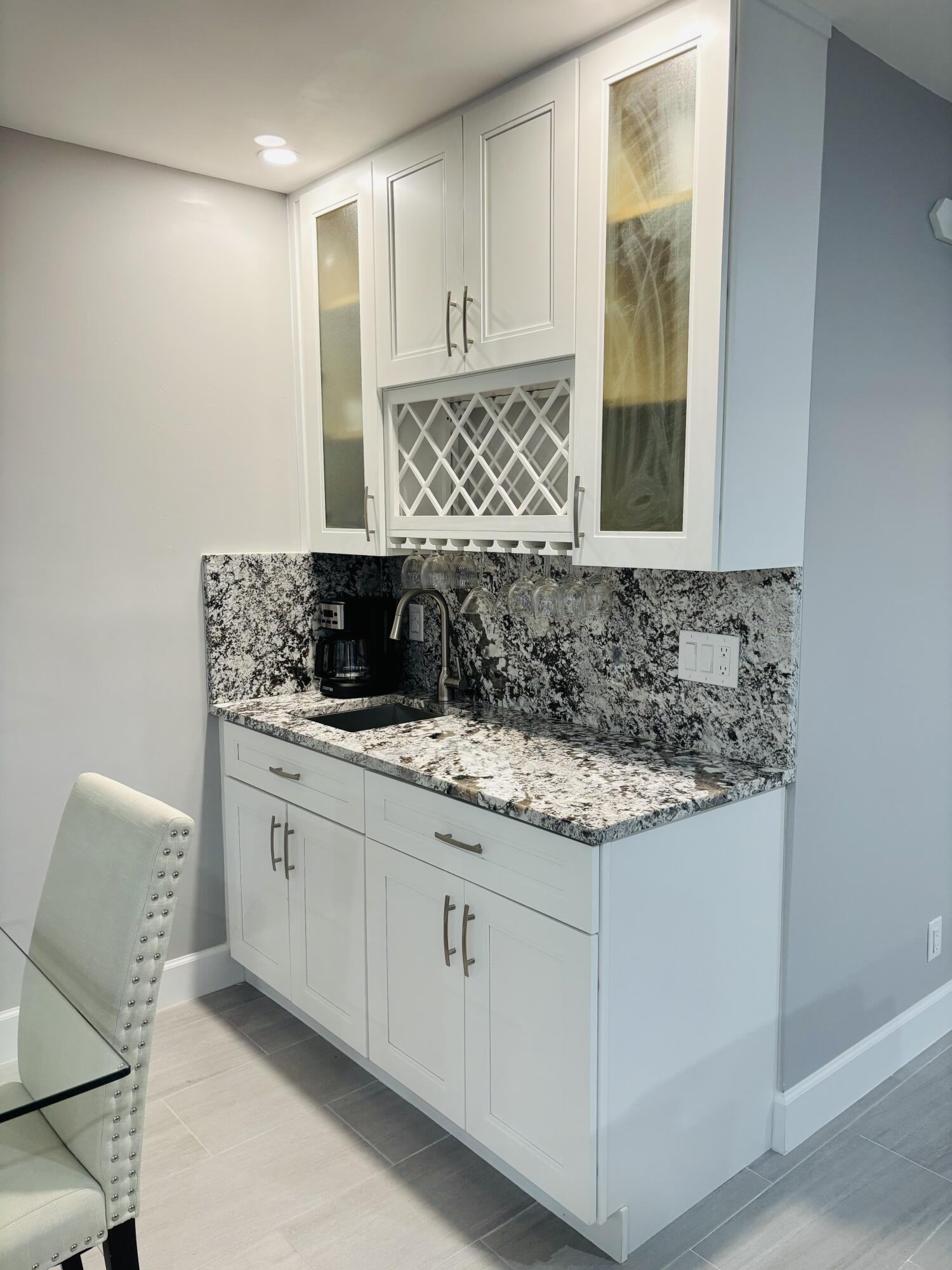 222 Southeast 3rd Street Boynton Beach, FL 33435 - Photo 6 of 40 a bathroom with a granite countertop sink and a window