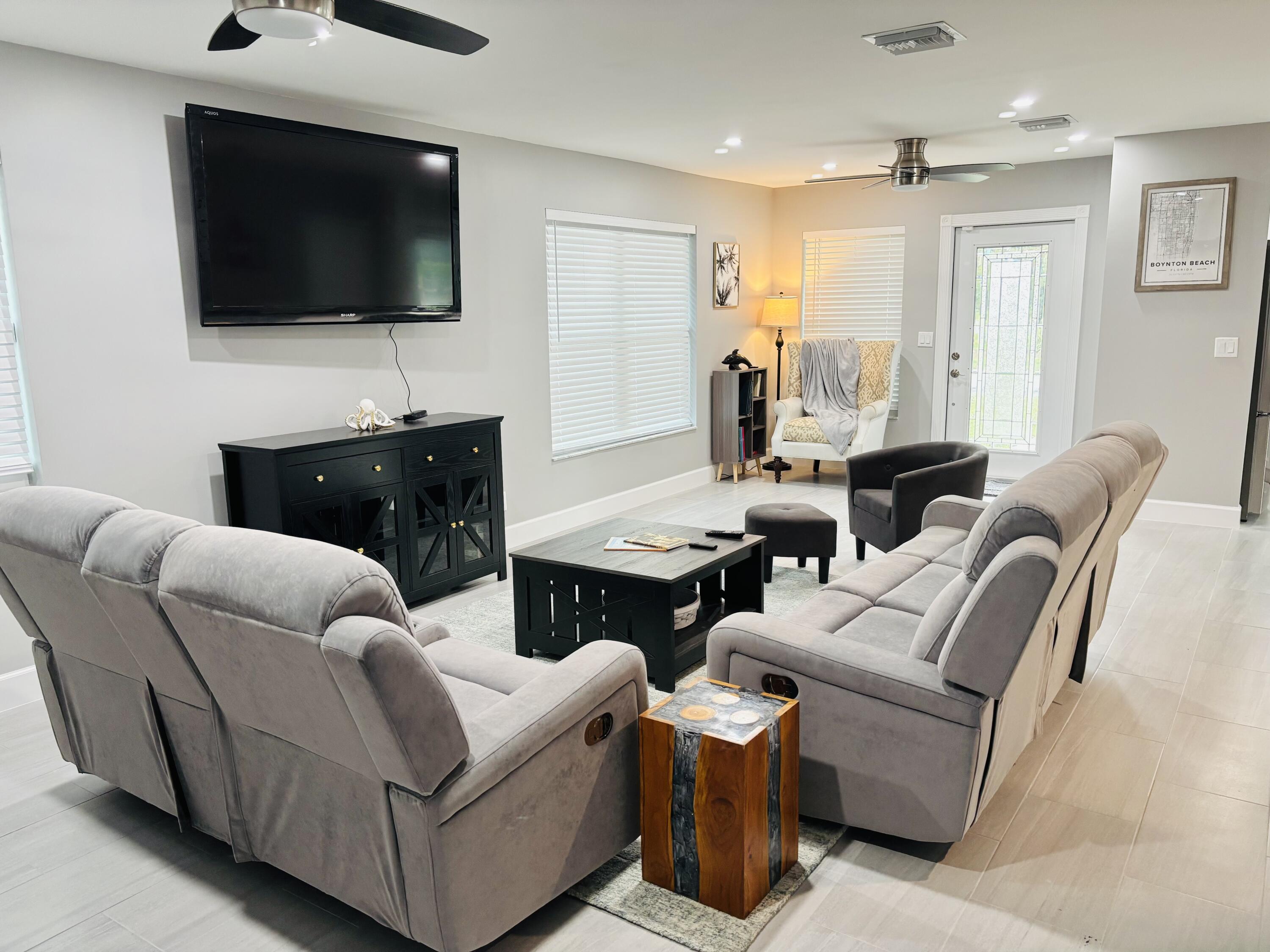 222 Southeast 3rd Street Boynton Beach, FL 33435 - Photo 9 of 40 a living room with furniture and a flat screen tv