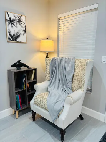 a living room with furniture and a lamp