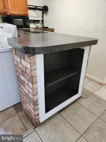 a stove top oven sitting inside of a kitchen