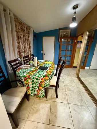 a bedroom with furniture and a gym machine