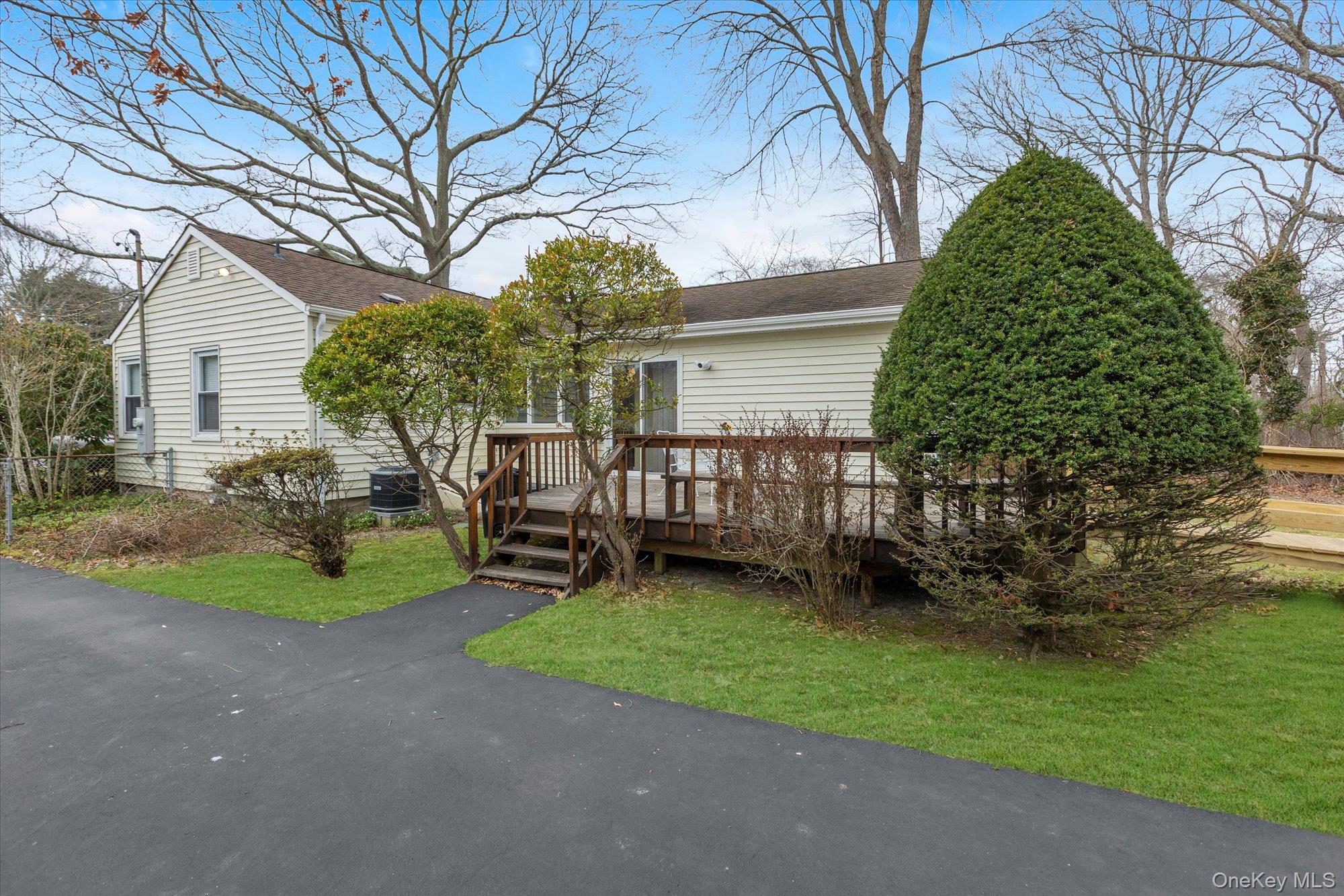 74 Country Club Road Bellport, NY 11713 - Photo 16 of 21 a view of a chair and table in backyard of the house