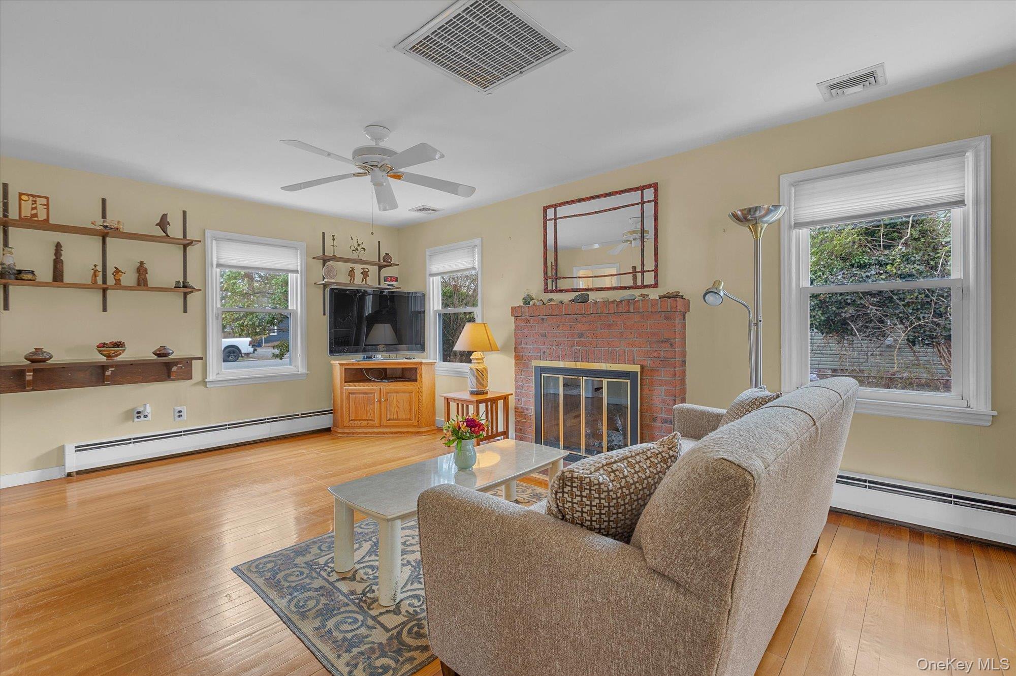 74 Country Club Road Bellport, NY 11713 - Photo 2 of 21 a living room with furniture and a fireplace