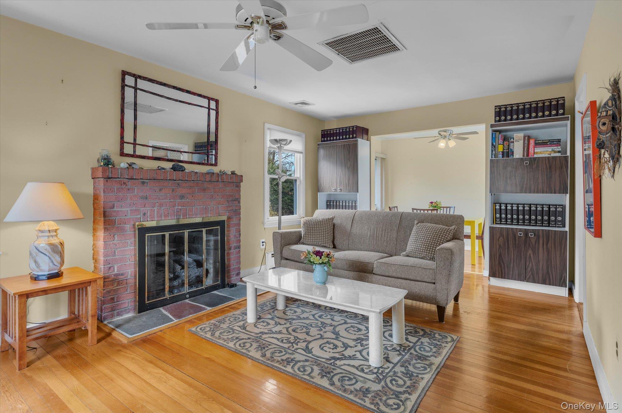 74 Country Club Road Bellport, NY 11713 - Photo 3 of 21 a living room with furniture and a fireplace