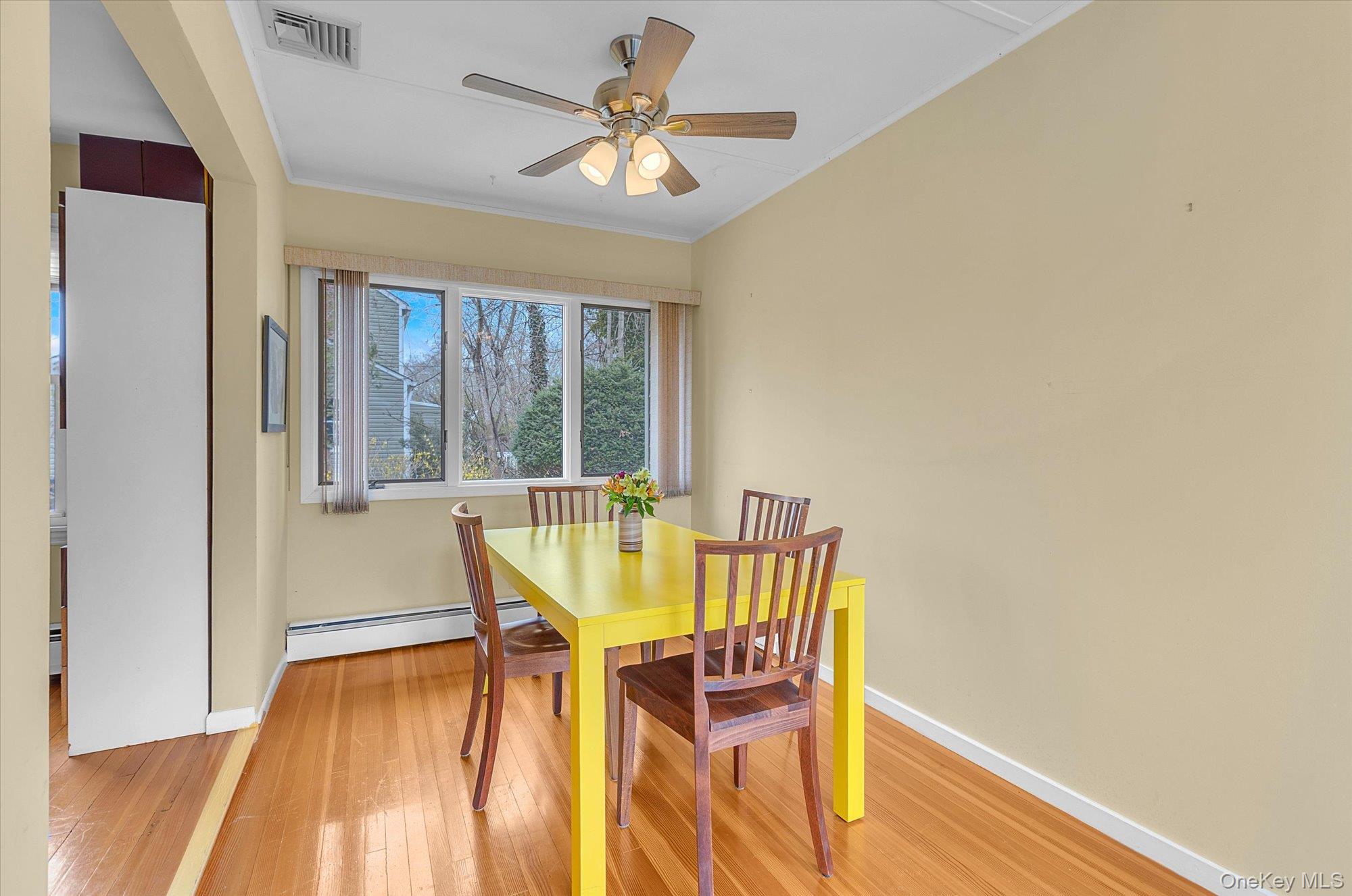74 Country Club Road Bellport, NY 11713 - Photo 6 of 21 a view of a dining room with furniture a chandelier and wooden floor