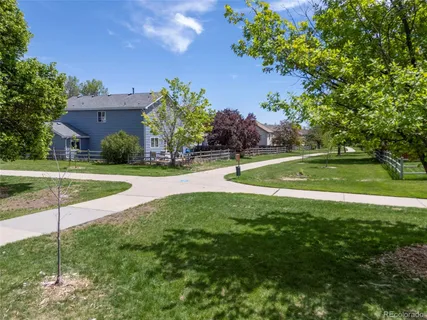 a view of a house with a backyard and a swimming pool