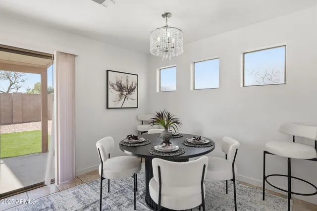 a view of a dining room with furniture and chandelier