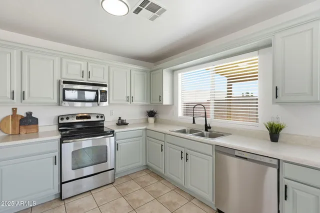 a kitchen with a sink stove and microwave