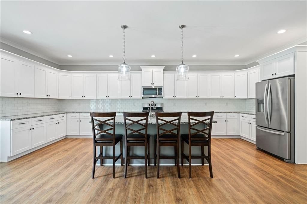 2 Village Ridge Jasper, GA 30143 - Photo 16 of 45 a kitchen with stainless steel appliances granite countertop a wooden table chairs refrigerator and sink