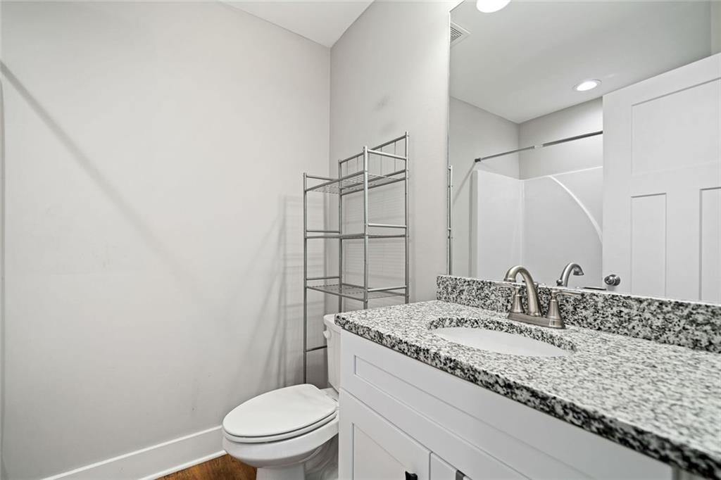 2 Village Ridge Jasper, GA 30143 - Photo 35 of 45 a bathroom with a granite countertop sink a toilet and a mirror
