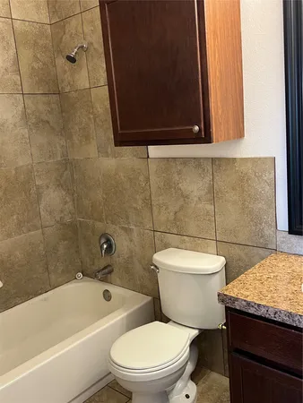 a bathroom with a toilet a sink and bathtub