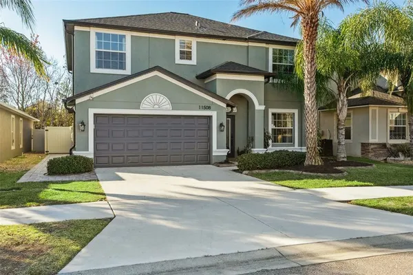 a front view of a house with a yard and garage