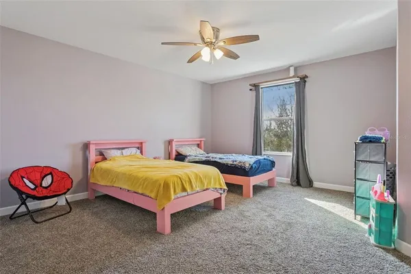 a bedroom with two beds and a chandelier