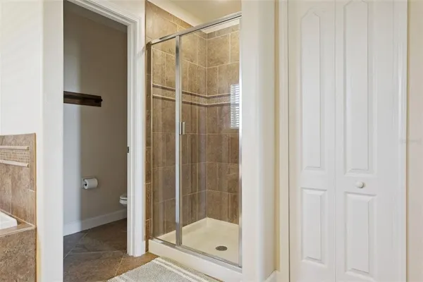 a bath tub sitting next to a white toilet