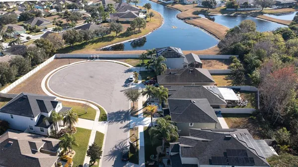 an aerial view of a house with garden space and a car park