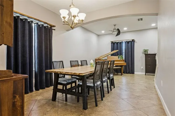 a view of a dining room with furniture and chandelier