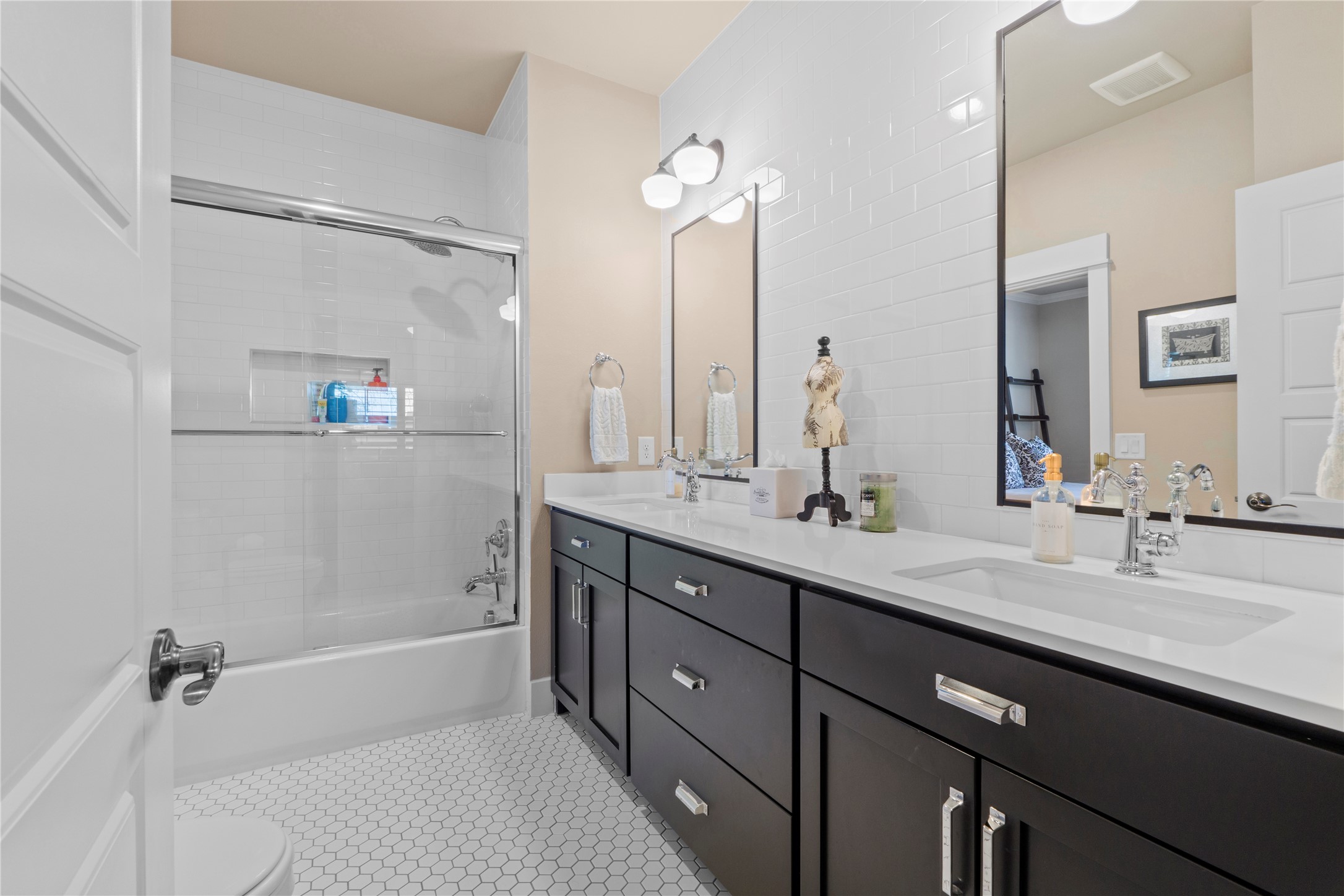 2004 Alegria Road Austin, TX 78757 - Photo 28 of 40 a bathroom with a double vanity sink a mirror and a bathtub