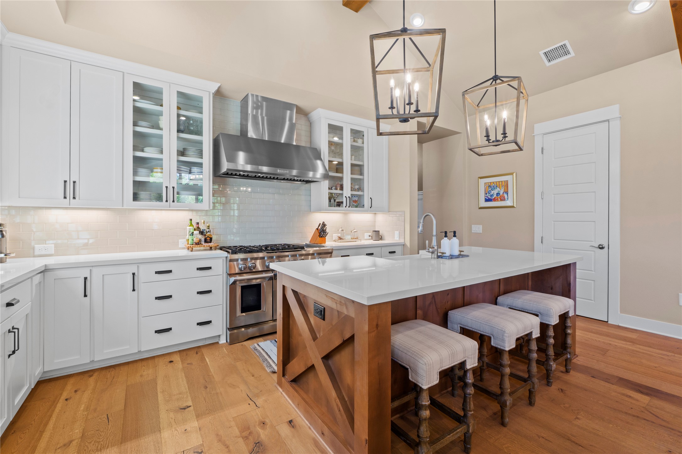 2004 Alegria Road Austin, TX 78757 - Photo 9 of 40 a kitchen with cabinets a sink dishwasher a dining table and chairs with wooden floor