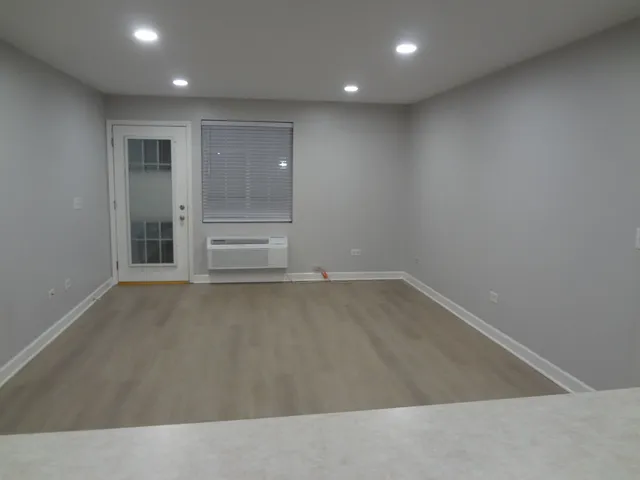 an empty room with wooden floor