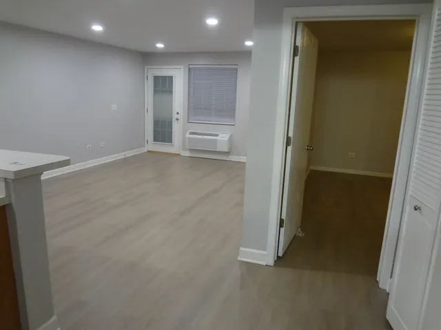 a view of an empty room with a kitchen