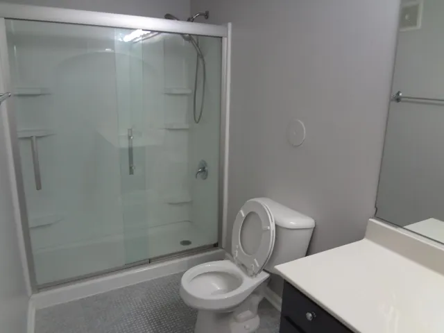 a white toilet sitting next to a bath tub