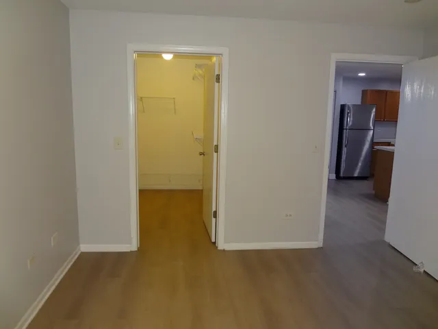 an empty room with wooden floor and closet
