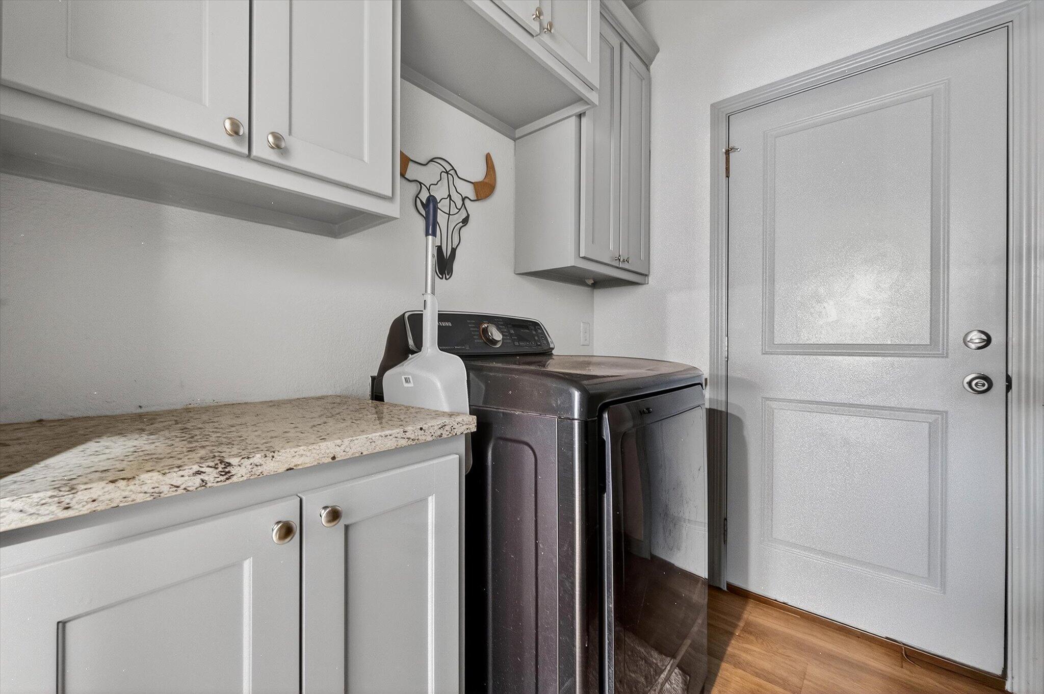 187 Allison Road Wilson, TX 79381 - Photo 17 of 35 a sink with cabinets and wooden floor