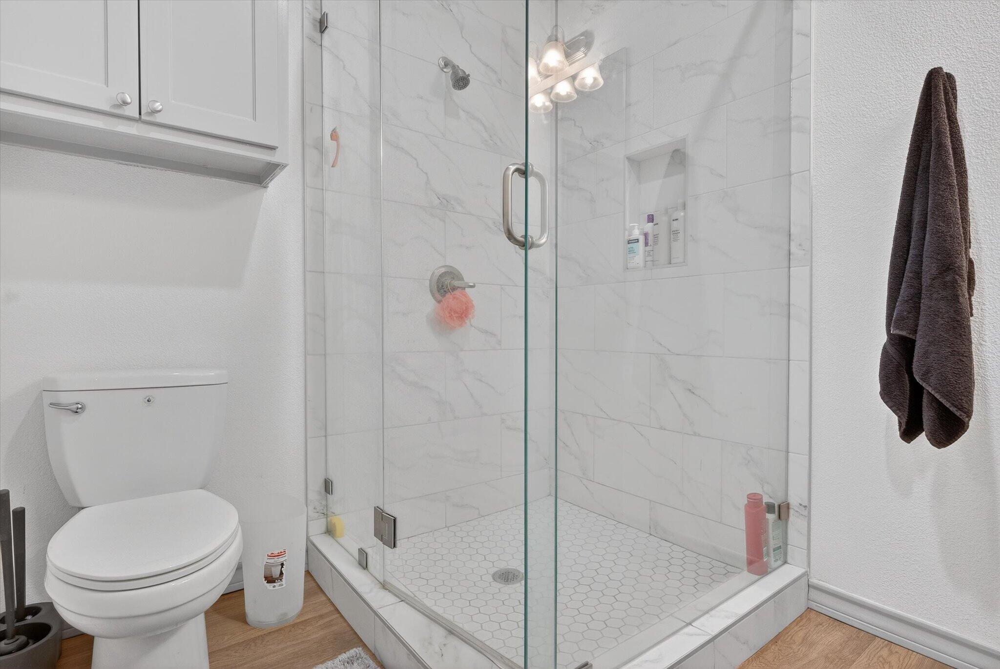 187 Allison Road Wilson, TX 79381 - Photo 23 of 35 a bathroom with a shower a toilet and a shower