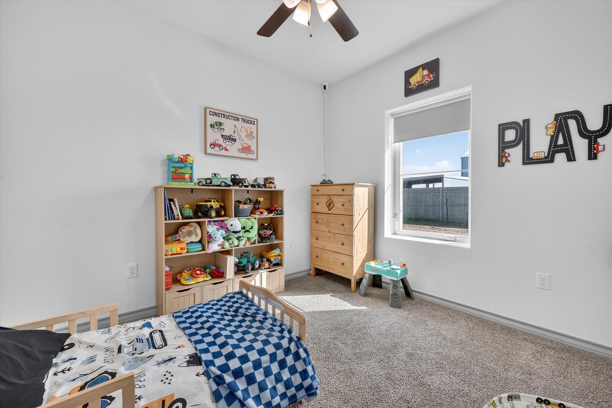 187 Allison Road Wilson, TX 79381 - Photo 24 of 35 a bedroom with bed and book shelf