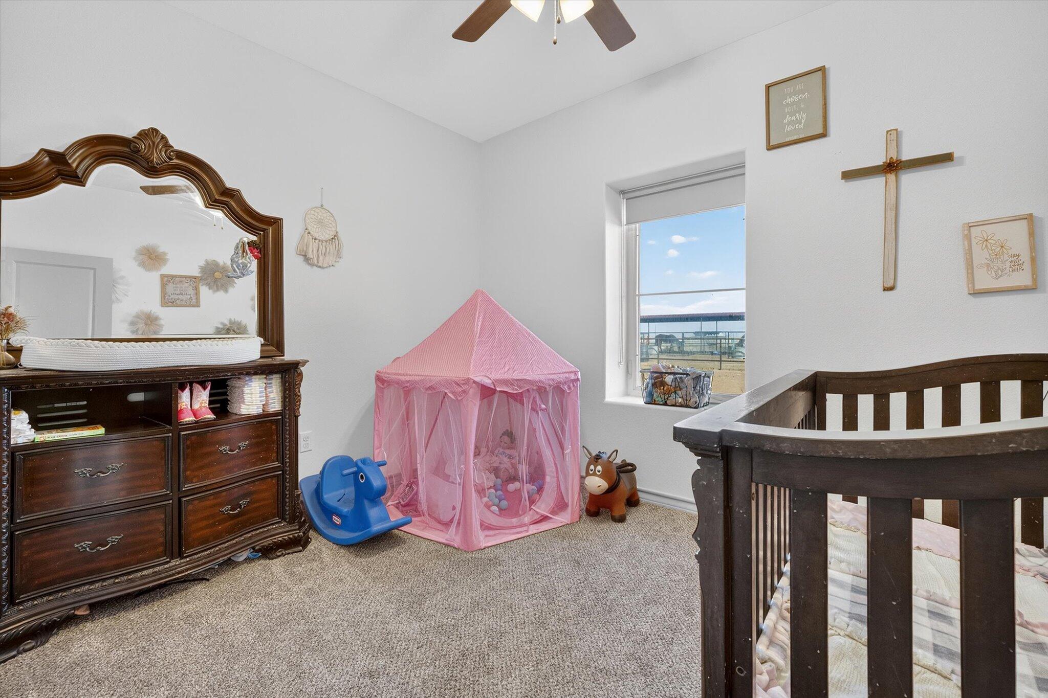 187 Allison Road Wilson, TX 79381 - Photo 26 of 35 a bedroom with furniture and a baby crib