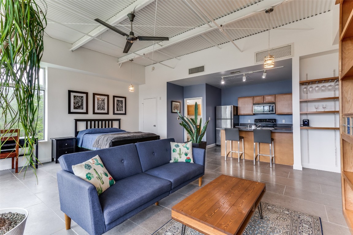 2401 East 6th Street, Unit 2031 Austin, TX 78702 - Photo 1 of 1 a living room with furniture kitchen view and a wooden floor