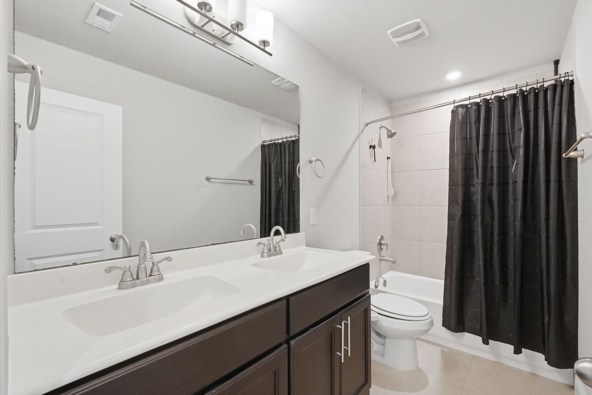 2809 Andante Green Drive Spring, TX 77386 - Photo 34 of 50 a bathroom with a double vanity sink toilet and shower