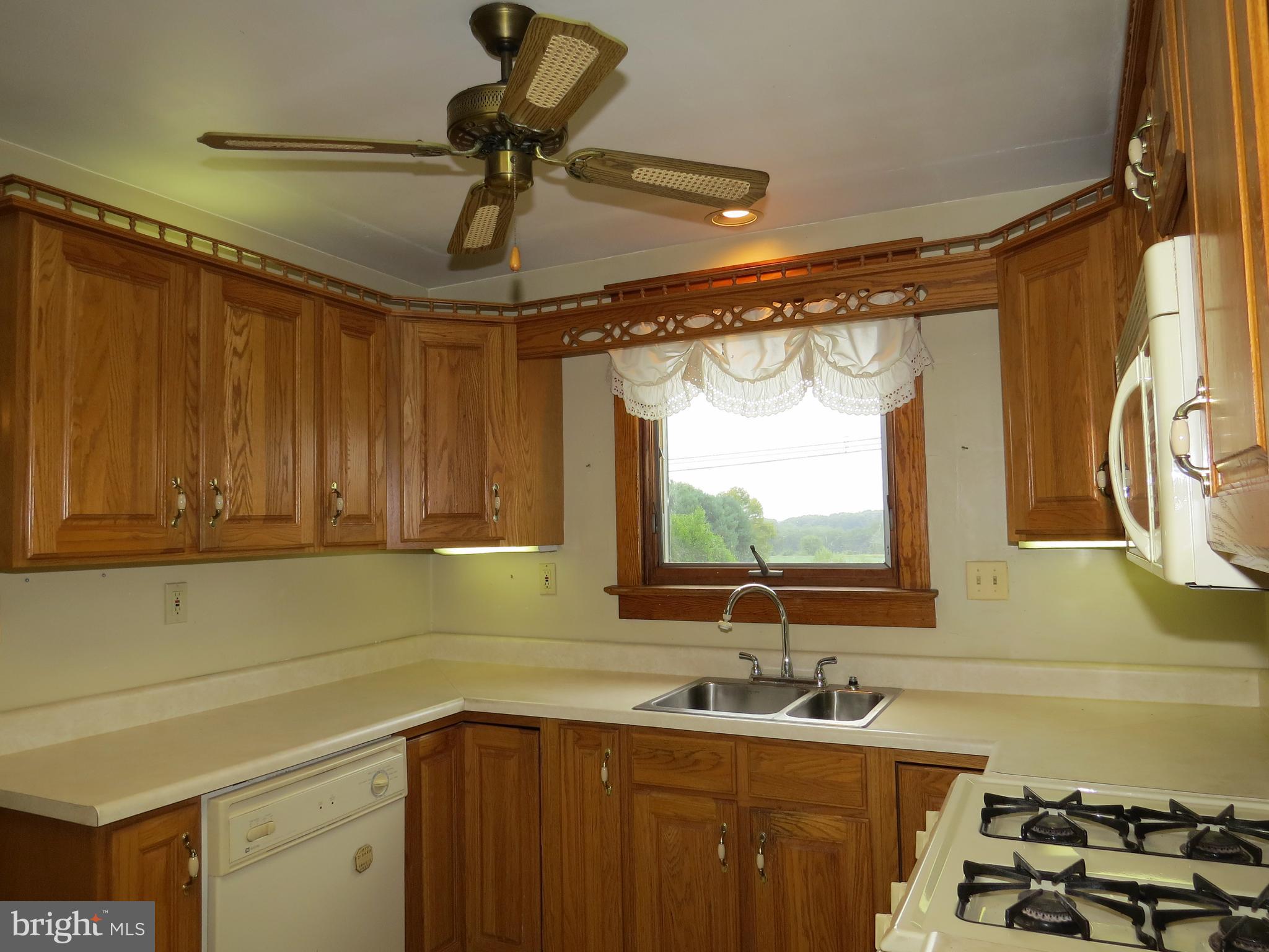 4418 Upper Beckleysville Road Hampstead, MD 21074 - Photo 4 of 25 a kitchen with a sink and cabinets
