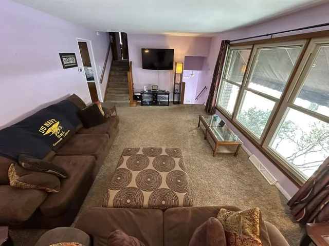 a view of kitchen with furniture and refrigerator