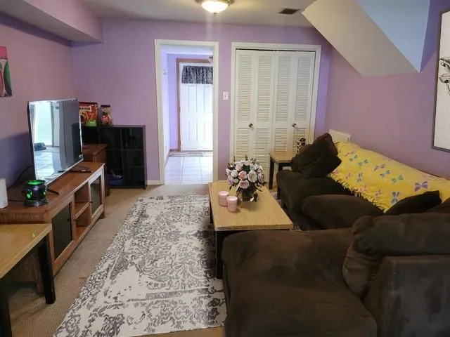 a bedroom with furniture and a flat screen tv