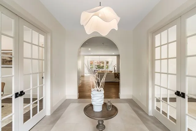 a dining room with chandelier and outdoor space