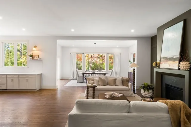 a spacious bedroom with a bed lamp and a large window