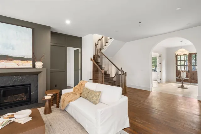 a living room with furniture and a potted plant