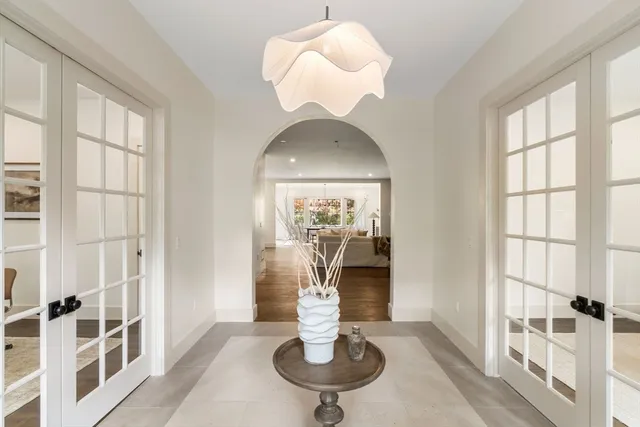 a view of a livingroom with furniture wooden floor and windows