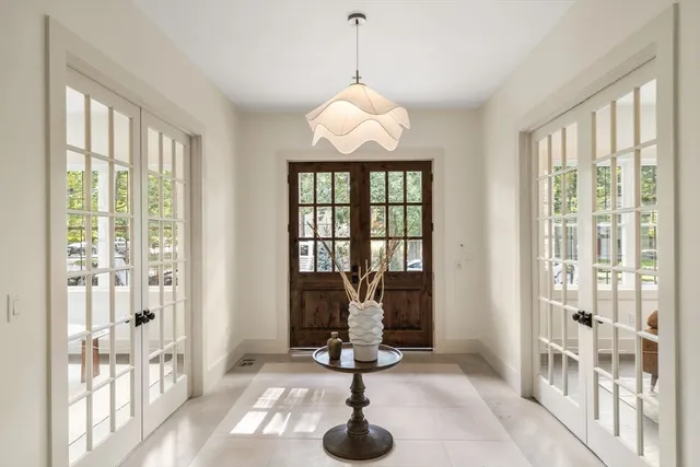 a view of a livingroom with furniture wooden floor and windows