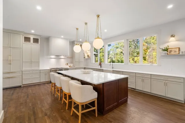 a kitchen with a dining table chairs and white cabinets