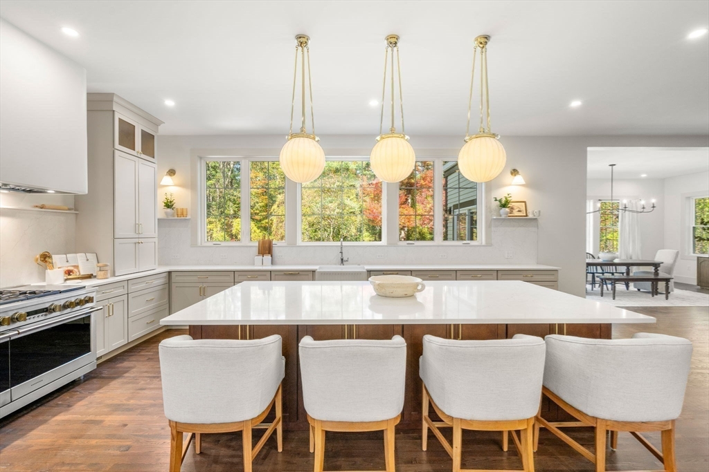 31 Porter Road Andover, MA 01810 - Photo 6 of 42 a kitchen with a dining table chairs and white cabinets