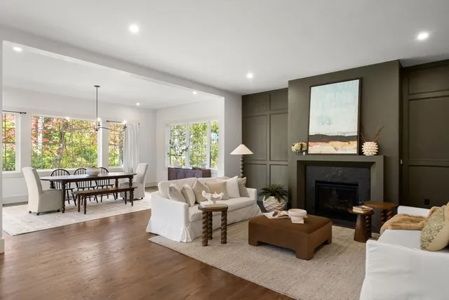 a dining room with furniture a chandelier and wooden floor