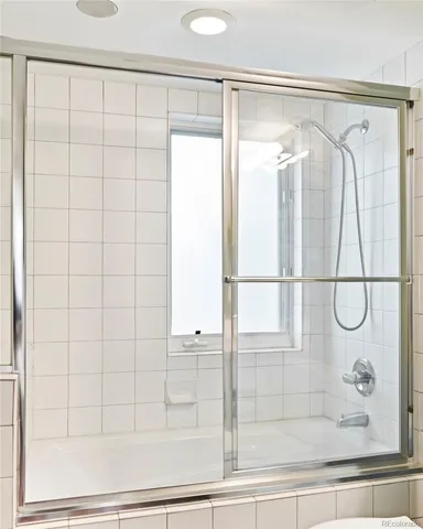 a bathroom with a glass shower door