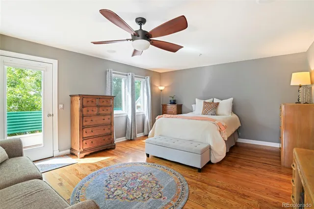 a spacious bedroom with a bed a window and a couch